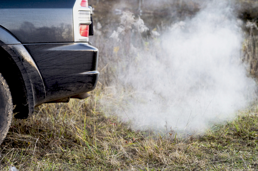 The Back Of The Black Car With The Emission Of Smoke From The Ex ...